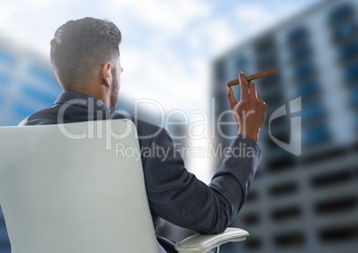 Businessman Back Sitting in Chair with cigar next to buildings