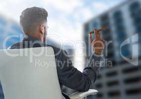 Businessman Back Sitting in Chair with cigar next to buildings