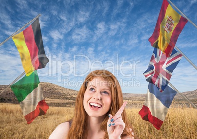 main language flags around young woman with a idea. field background