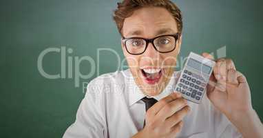 Man smiling with calculator against green chalkboard