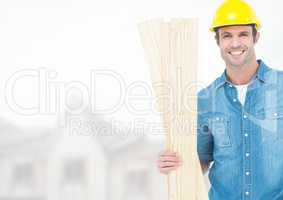 Carpenter with wood on building site