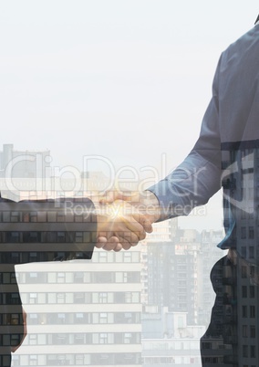 Businessmen handshake and city overlap. flares in the middle of the handshake
