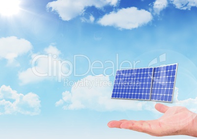 Digital composite image of hand below solar panels against sky
