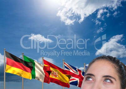 main language flags behind foreground of young woman thinking