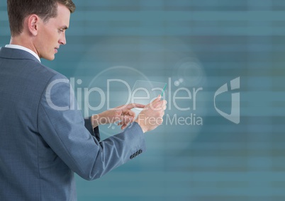 Businessman holding glass tablet with blue lined background