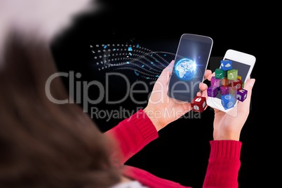 Woman holding two phones with graphics