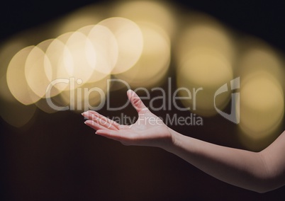Hand reaching asking in wonder with sparkling light bokeh background
