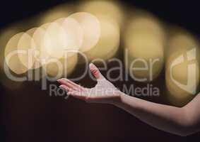 Hand reaching asking in wonder with sparkling light bokeh background