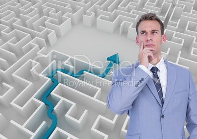 Businessman thinking in front of white background with a blue arrow in a  labyrinth