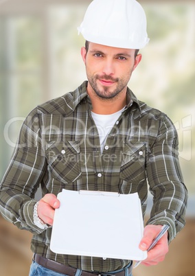 Construction Worker with pen chart in front of construction site