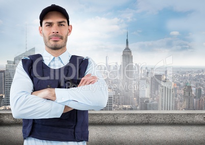 Security guard with arms folded against skyline