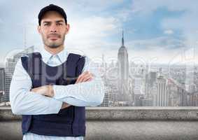 Security guard with arms folded against skyline