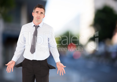 Sad businessman with empty pocket with city background