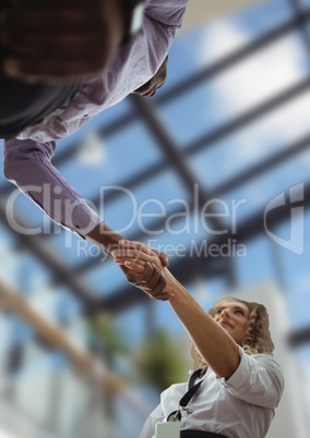 business man and woman handshake, sky view in the office