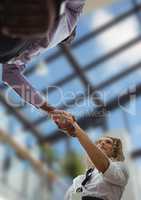 business man and woman handshake, sky view in the office