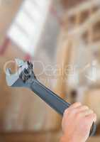 Hand with wrench on building site