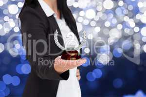 Business woman holding trophy against fireworks background
