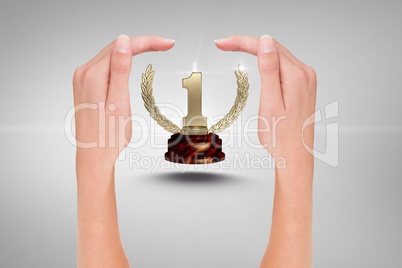trophy surrounded by hands against grey background