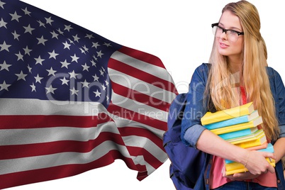 Girl student with books against american flag
