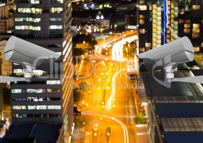 High angle view of CCTV cameras against lights in city