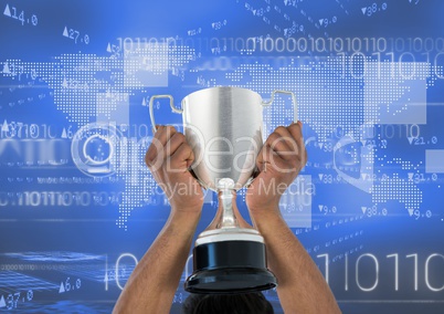 Digital composite image of hands holding trophy against binary codes