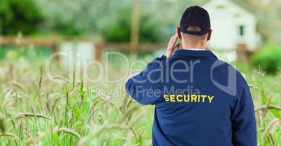 Rear view of security guard on field