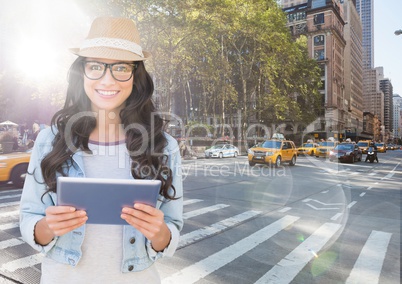 Trendy woman with tablet against sunny street with flares