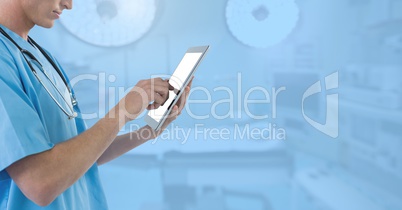 Doctor holding tablet in blue surgery operating theatre