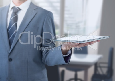 Businessman holding tablet in office