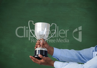 business hand with trophy, green background