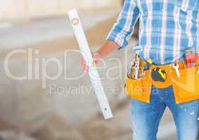 Carpenter with spirit level on building site