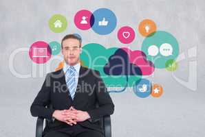business man sitting in chair with icons on the wall