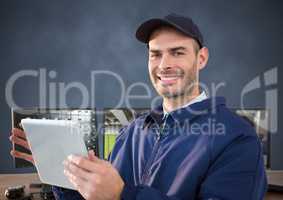 security guard smiling in front of the computers with tablet