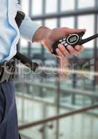 Security guard with walkie-talkie in the office with a blurred back