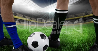 soccer players foots with ball in the field