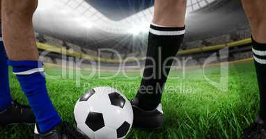 soccer players foots with ball in the field