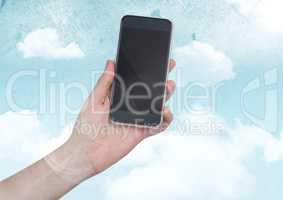 Hand with phone against sky with flare