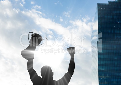 businessman hand with trophy shade with building and sky