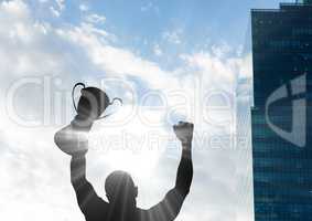 businessman hand with trophy shade with building and sky