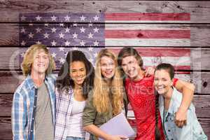 students arm in arm against American flag on wooden wall