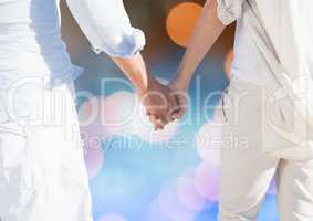 Couple holding Hands with sparkling light bokeh background