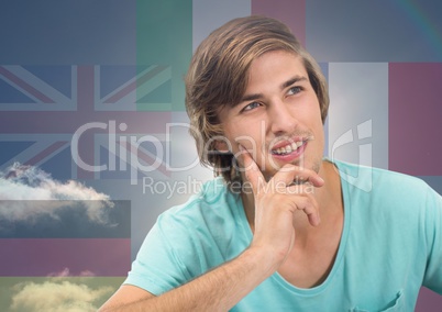 main language flags around young happy man thinking. Sky background