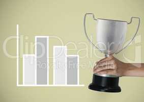 Cropped hand holding trophy against graph