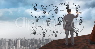 Digital composite image of businessman drawing light bulbs on clouds over city