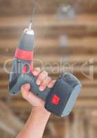 Hand with drill on building site
