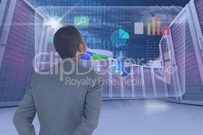 Businessman watching digital screen with graphics
