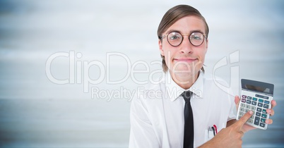 Man looking up with calculator against blurry blue wood panel