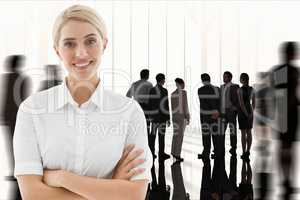 Businesswoman crosses her arms against workplace background