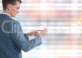 Businessman holding glass tablet with colorful background