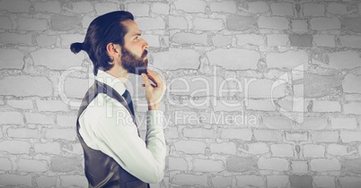 Reflecting hipster man in front of grey stone wall